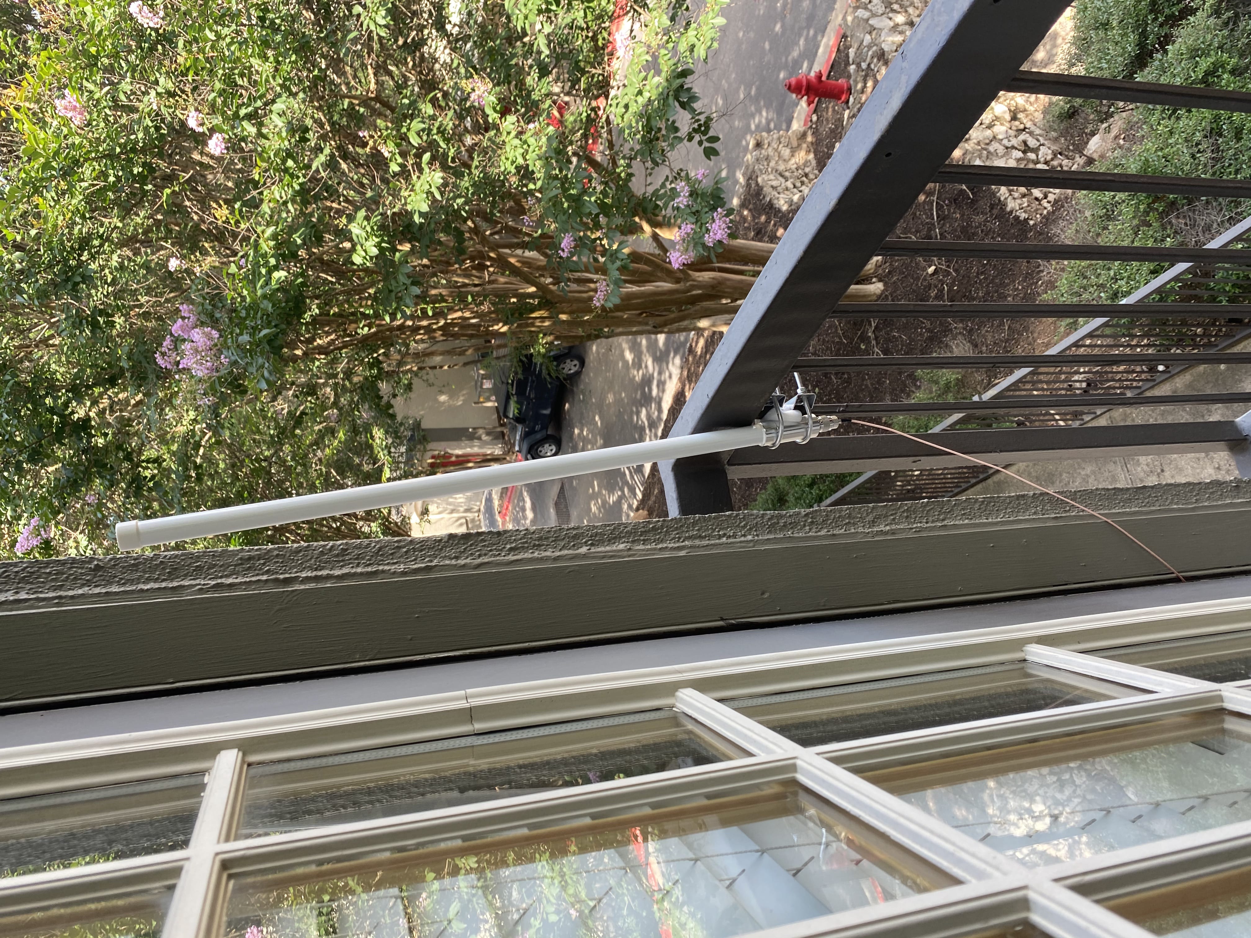 A big white antenna mounted on a little rail on a balcony... it doesn't inspire confidence haha