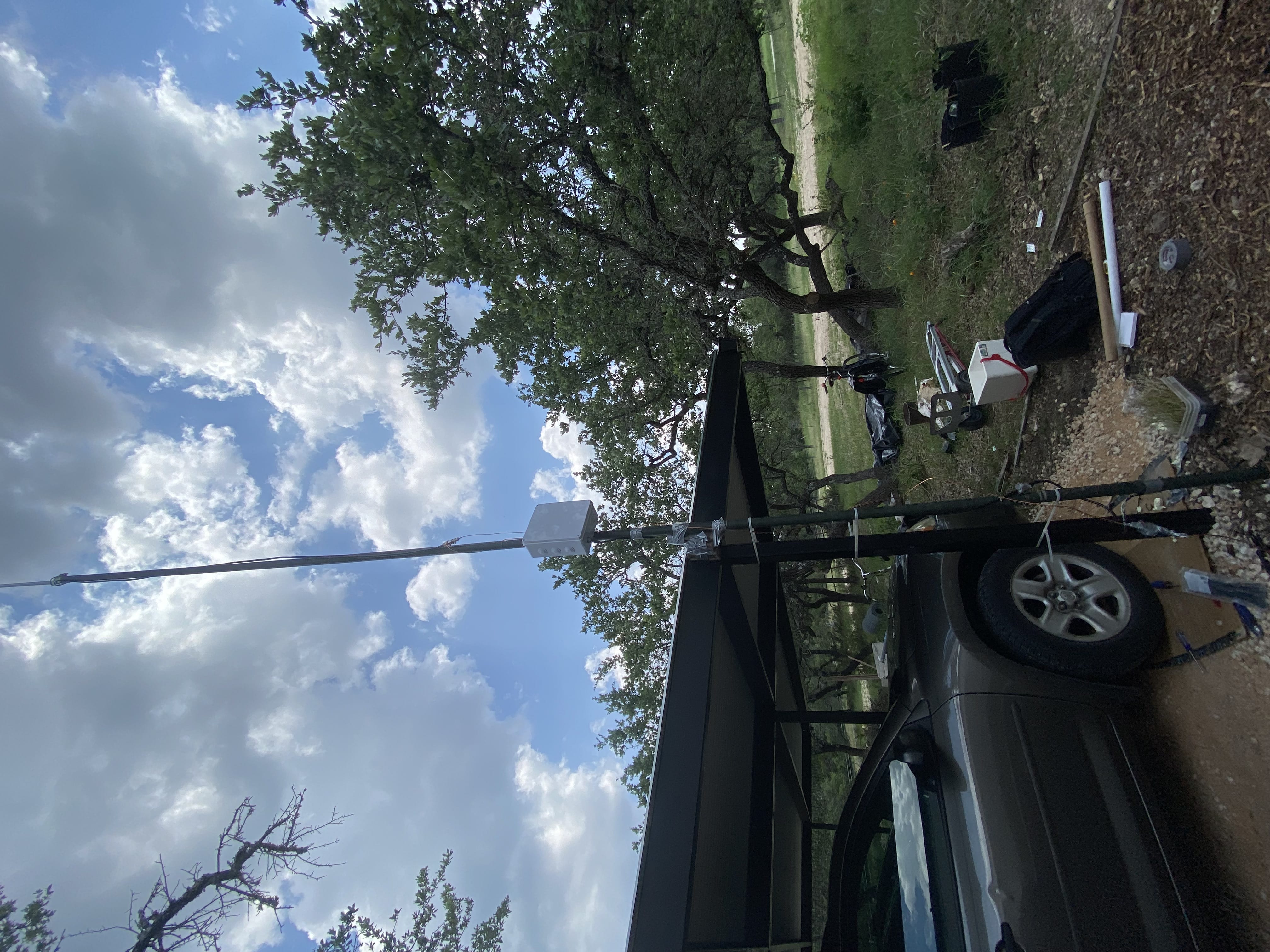 An antenna resting against an outdoor carport