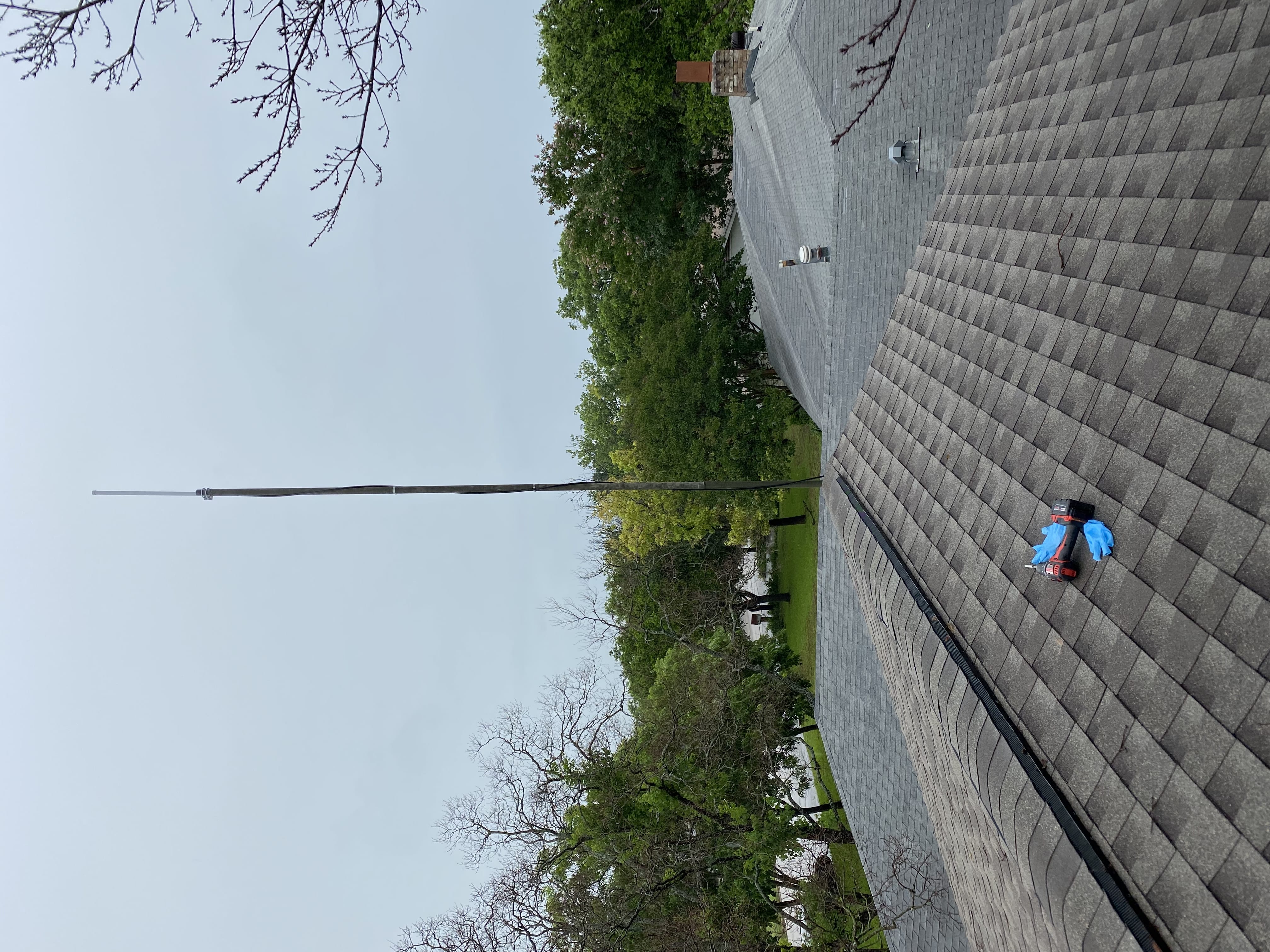 A big antenna coming up out of a roof