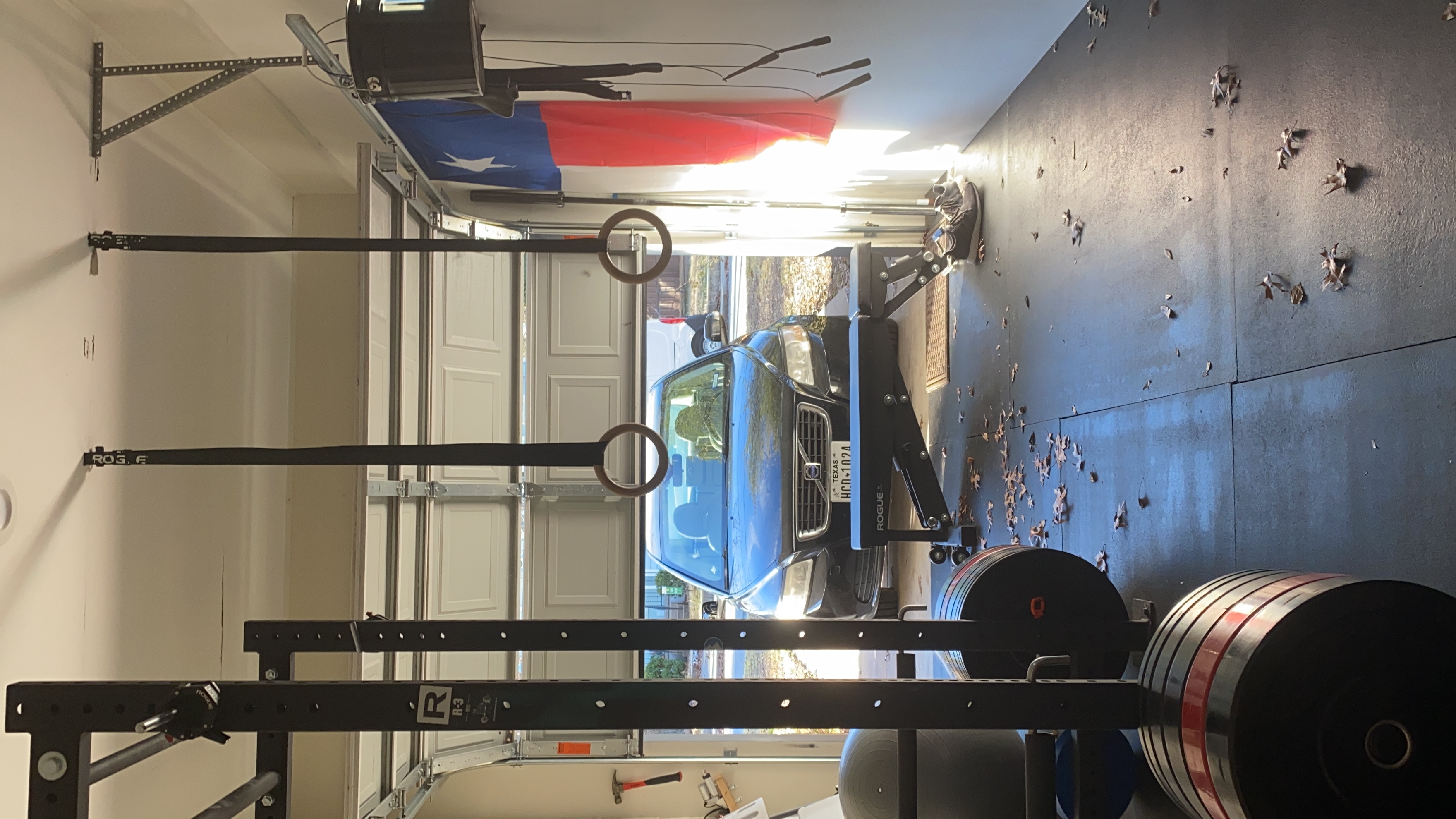 Rogue rings, hanging from the ceiling of a garage, with a car in the driveway.