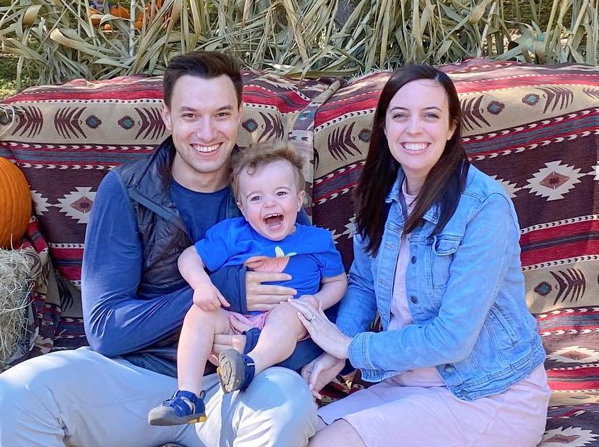 Me, my wife, and my 2-yr old son, sitting in front of a bail of hay.